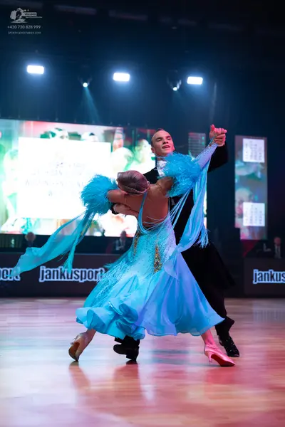 Dancesport competitor: Male dancer: black suit with a white shirt and white bowtie