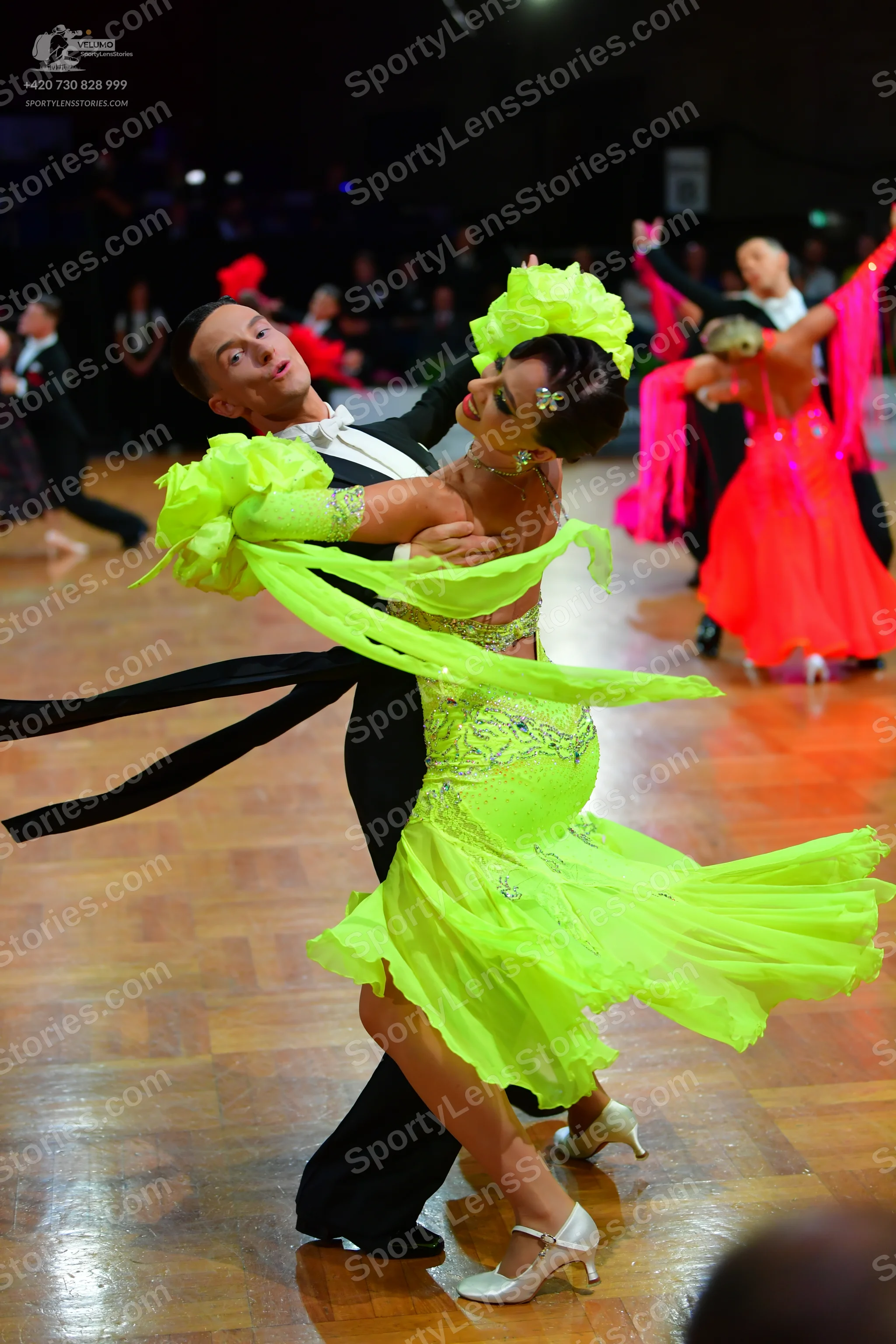 Dancesport competitor: Main female dancer: neon lime green latin dress with a sequined bodice and a lay