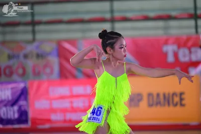 Dancesport competitor: ** Bright Yellow Latin Dress
*   **Color:** Vibrant yellow
*   **Fabric:** Likel