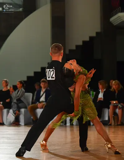 Dancesport competitor #102: Male dancer: black short-sleeved t-shirt and black trousers