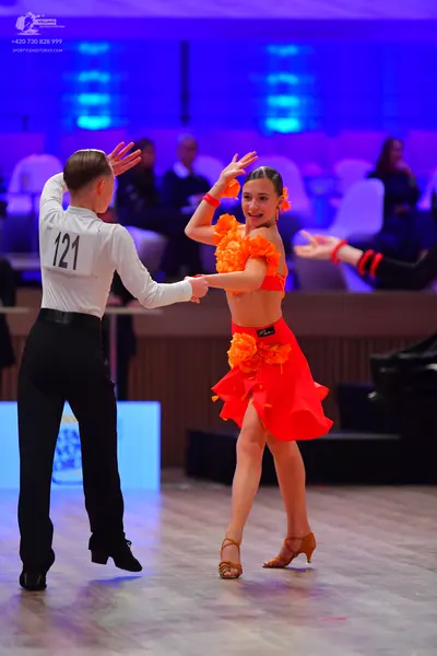 Dancesport competitor: Male dancer: white long-sleeved shirt and black trousers