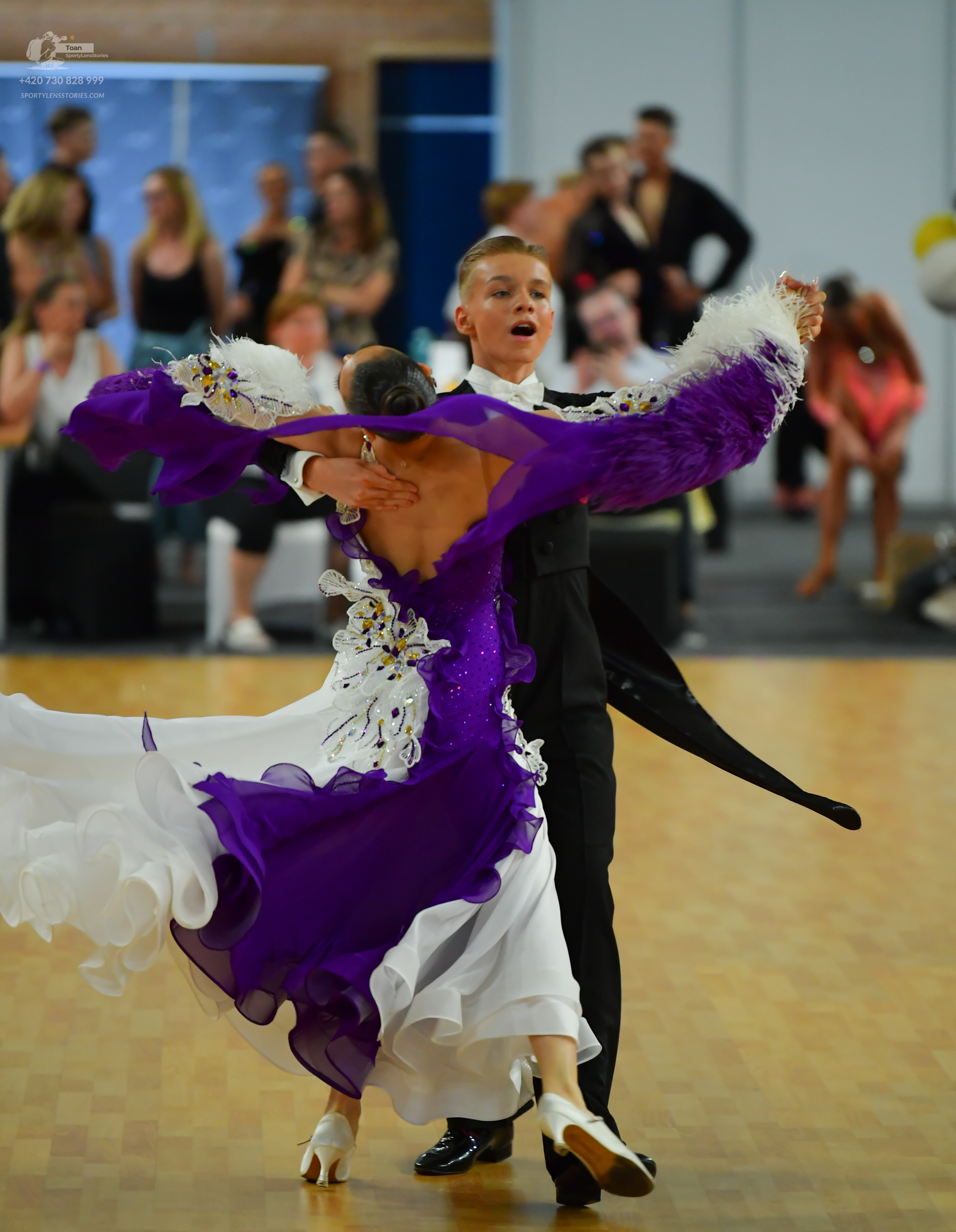 Dancesport competitor: ** Male: Black tail suit with silver sequin lapels and matching shoes