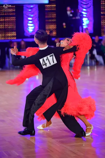 Dancesport competitor #417: Male dancer: black long-sleeved shirt with a white collar and black trousers wit