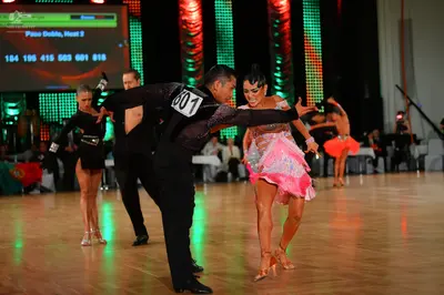 Dancesport competitor #601: Male dancer: black long-sleeve shirt with a white competition number on the back