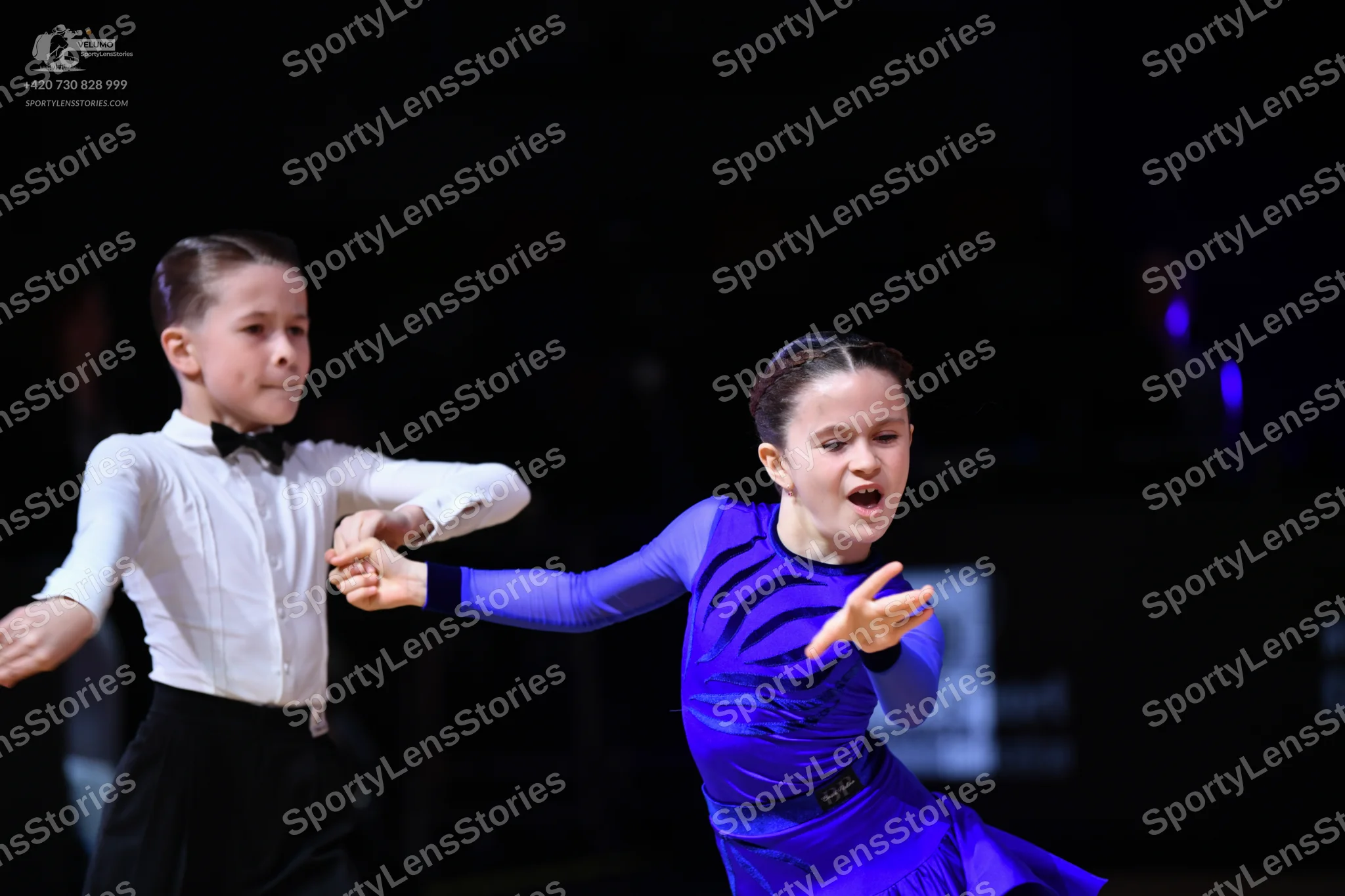 Dancesport competitor: Male dancer: white long-sleeved shirt, black bow tie, and black trousers