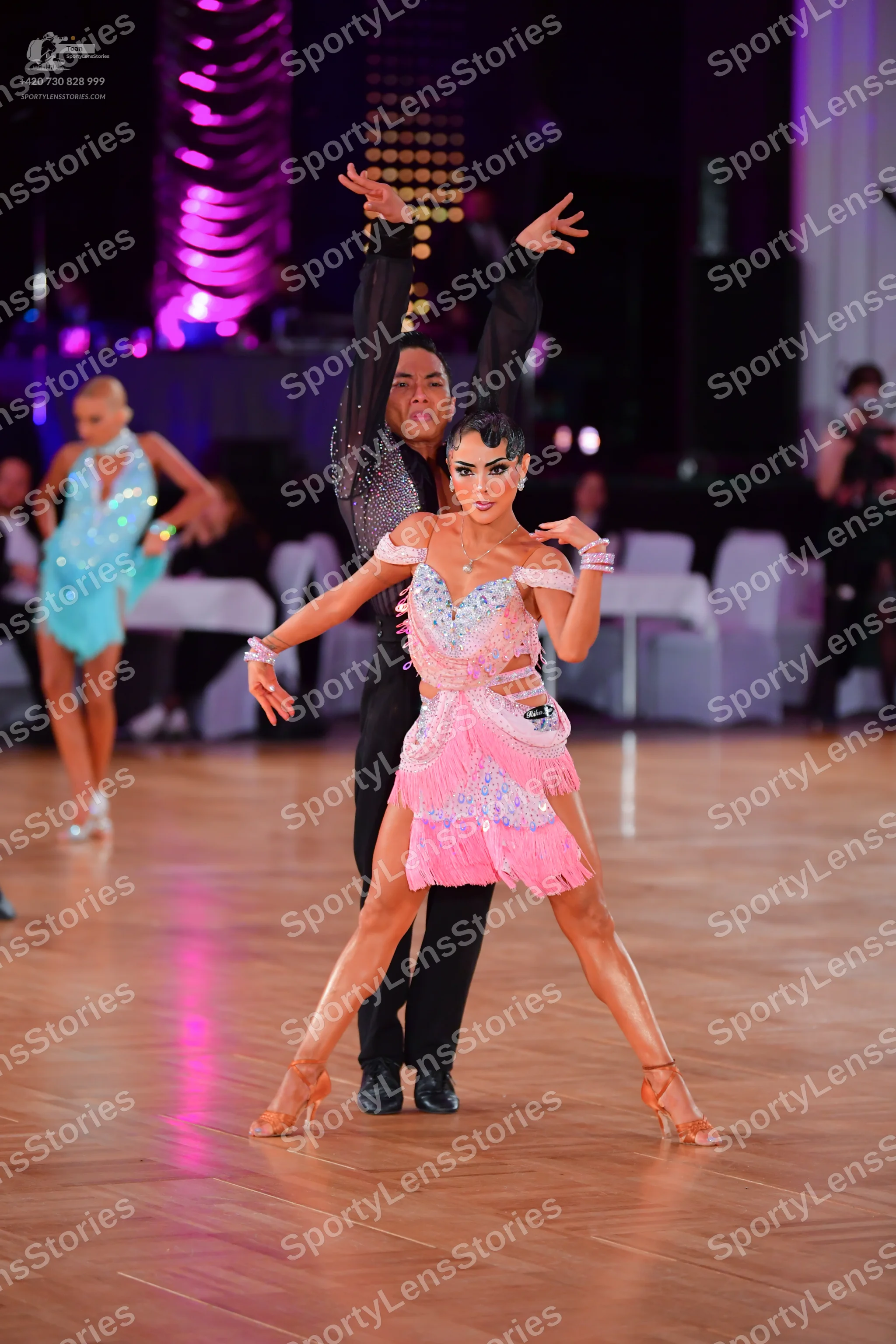 Dancesport competitor: Female dancer: light pink latin dress with sequins and fringe, and matching wris