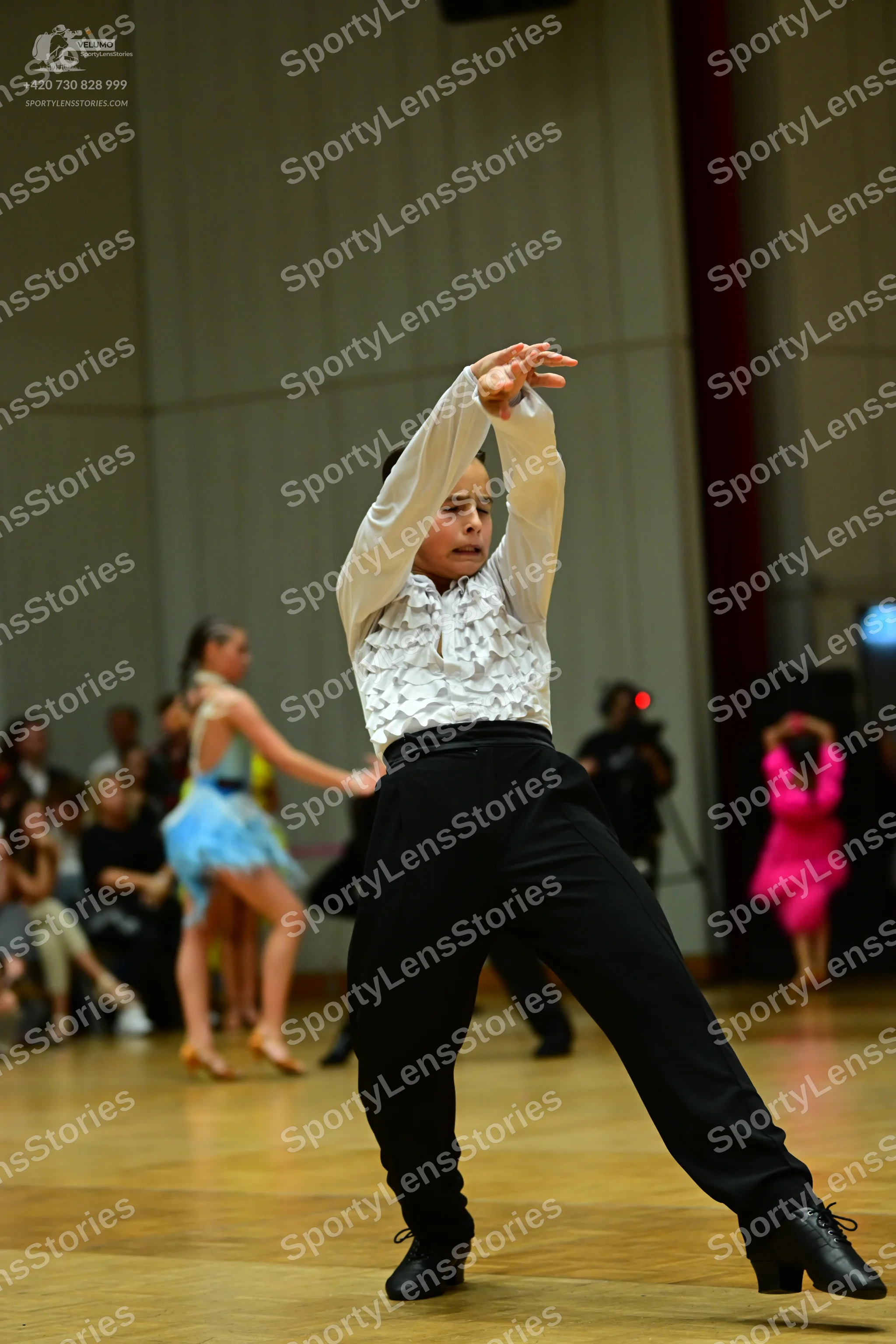 Dancesport competitor: Male dancer: white long-sleeved shirt with ruffled chest and black trousers