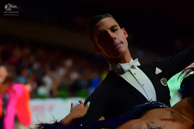 Dancesport competitor: Male dancer: black suit with a white shirt and white bowtie