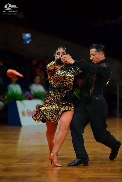 Dancesport competitor: Female dancer: leopard print Latin dress with dark lace or sequin details