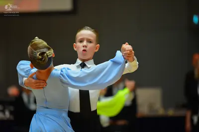 Dancesport competitor: Male dancer: white long-sleeved shirt with a black tie and black waistcoat
