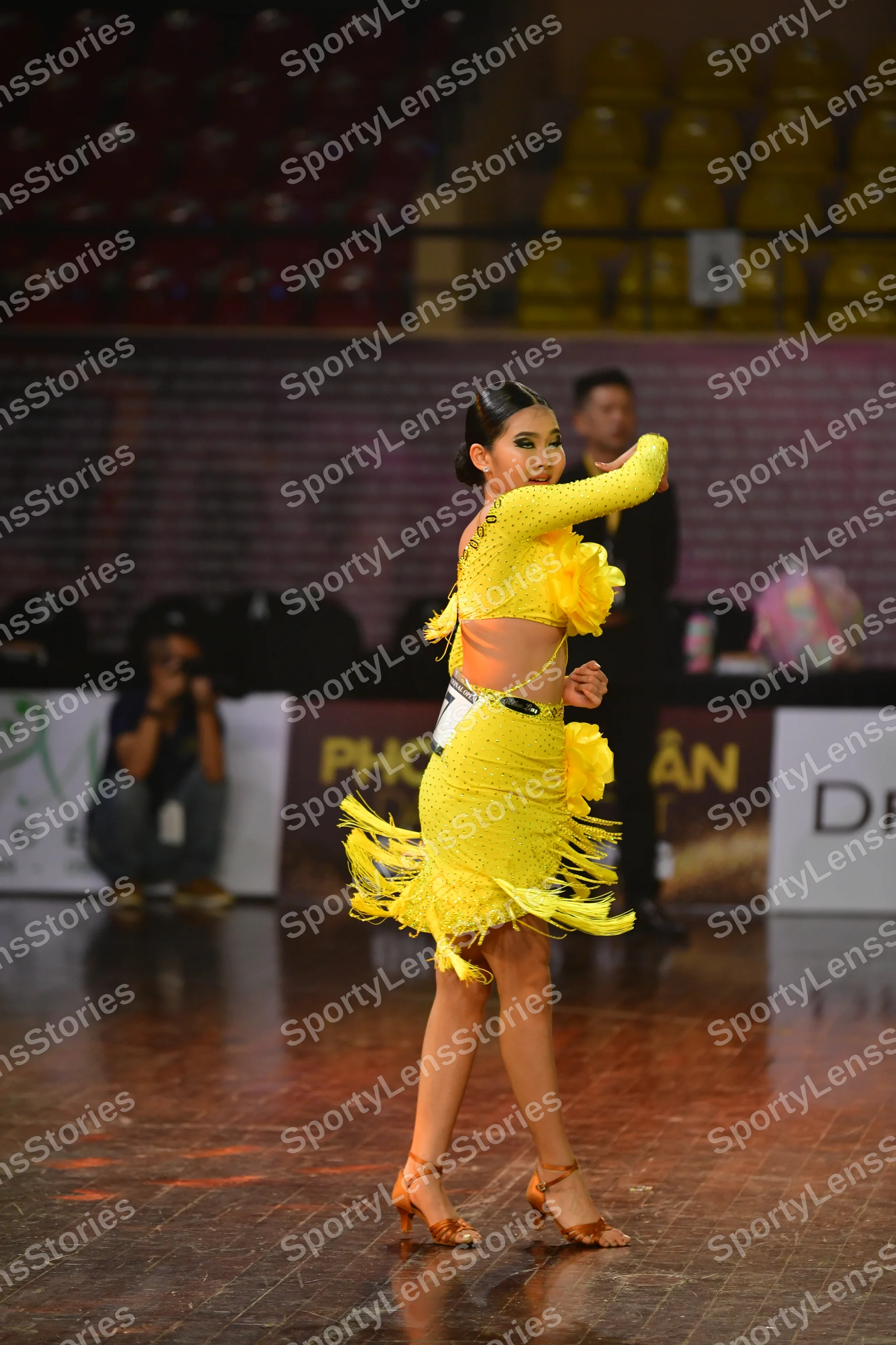Dancesport competitor #145: Female dancer: yellow Latin dress with long sleeves and fringe on the skirt