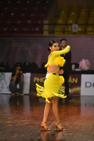 Dancesport competitor #145: Female dancer: yellow Latin dress with long sleeves and fringe on the skirt