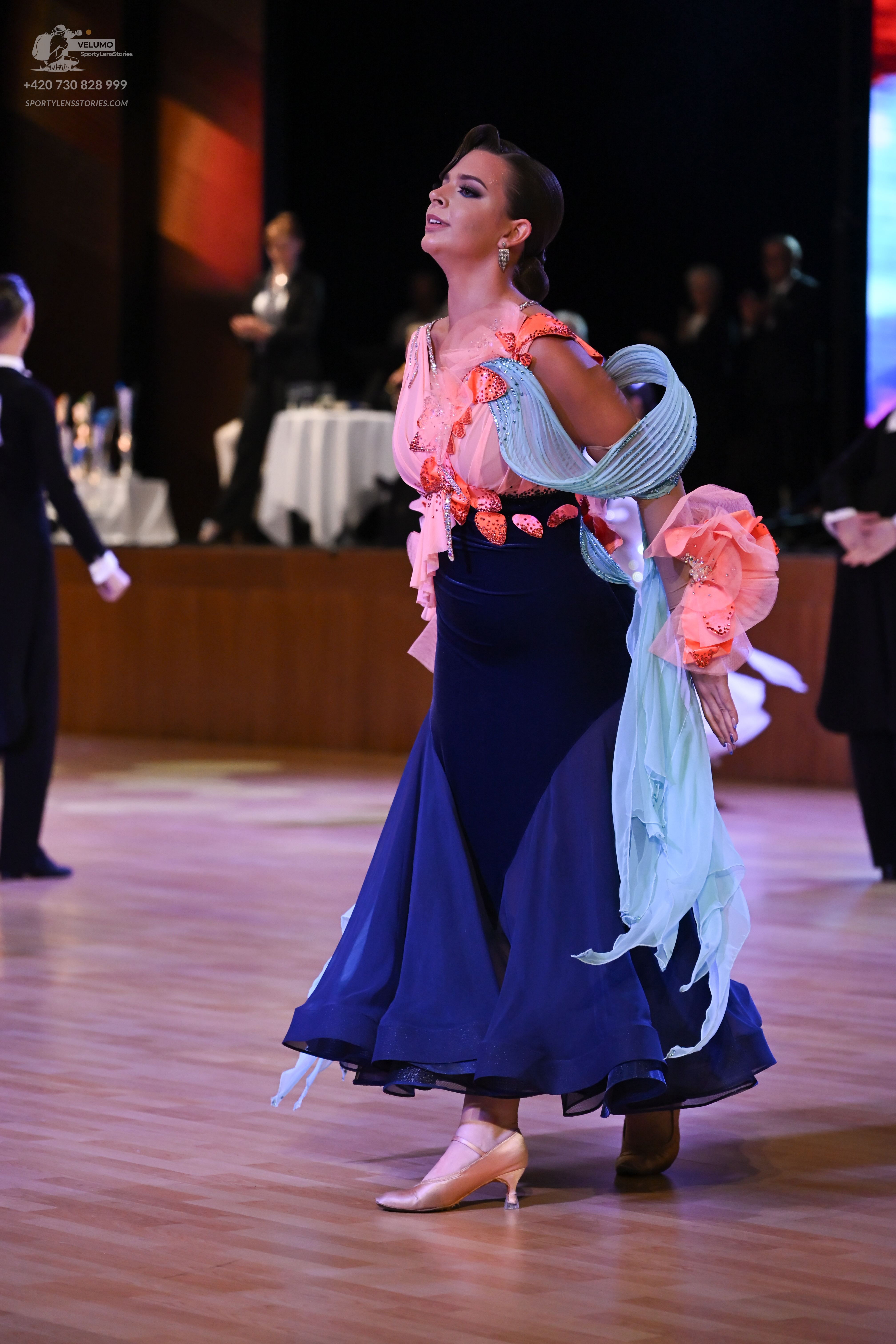 Dancesport competitor: ** Red Latin dress with a flowing, asymmetrical hemline