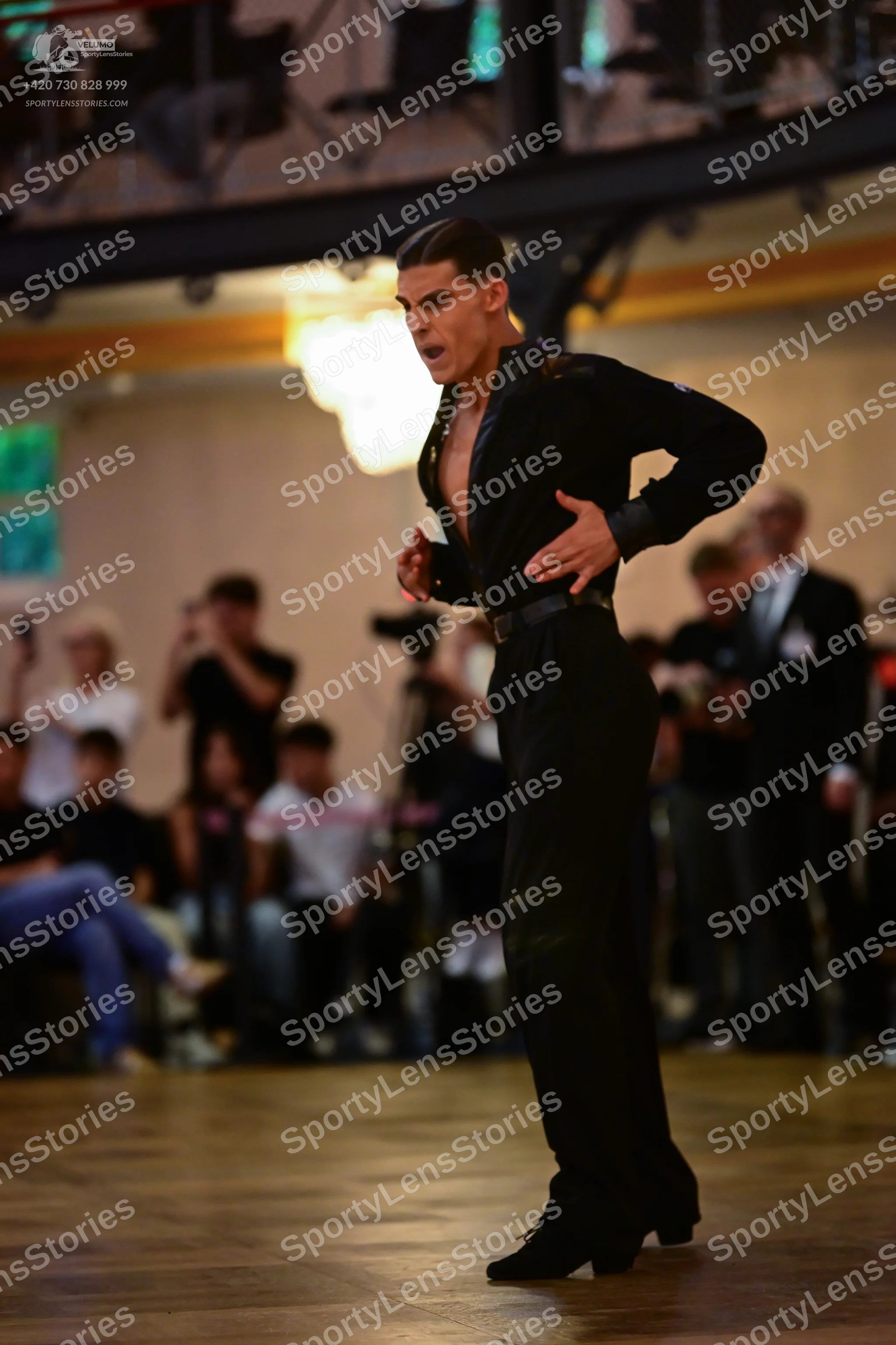 Dancesport competitor: Male dancer: black long-sleeved shirt with a slight sheen, worn open at the ches