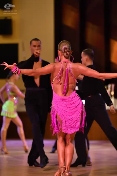 Dancesport competitor: ** Pink Latin dress with a dramatic, flowing fringe
