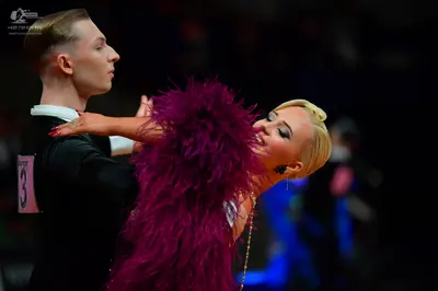 Dancesport competitor: Male dancer: black suit with a white shirt collar
