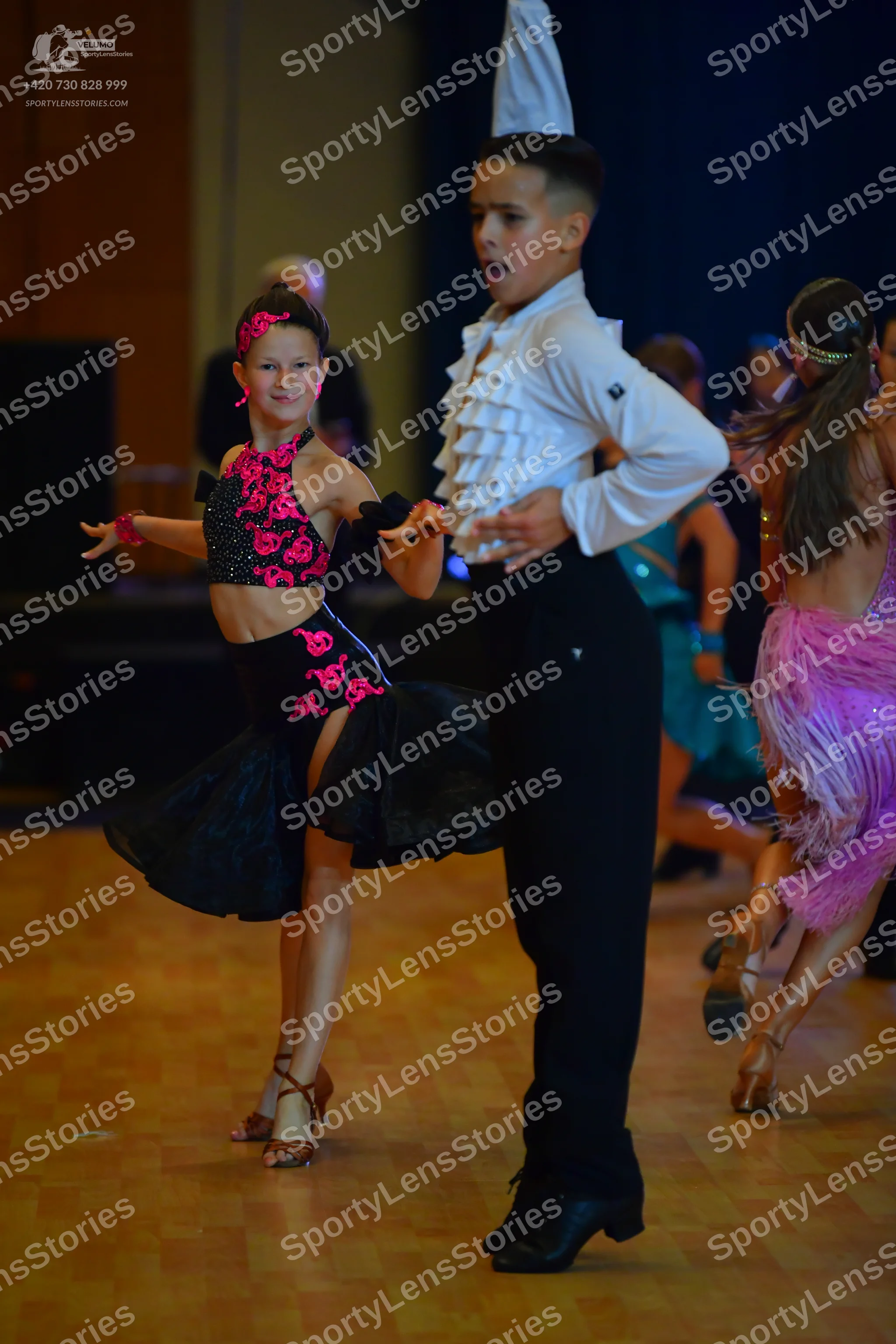 Dancesport competitor: Male dancer: white shirt with ruffles on the front and black trousers