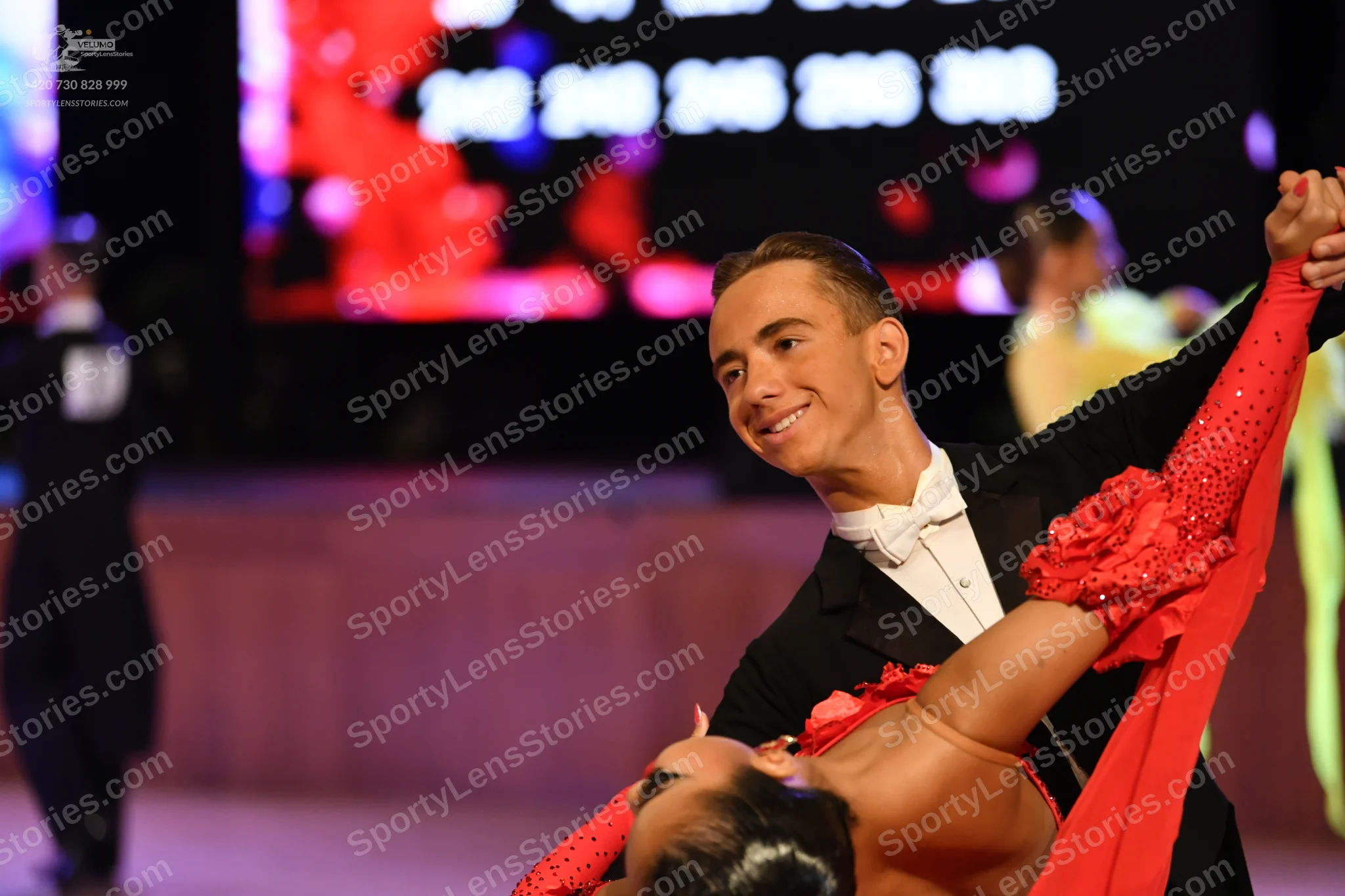 Dancesport competitor: Male:** Black suit with white shirt, black bow tie, and black tailsuit with sequ