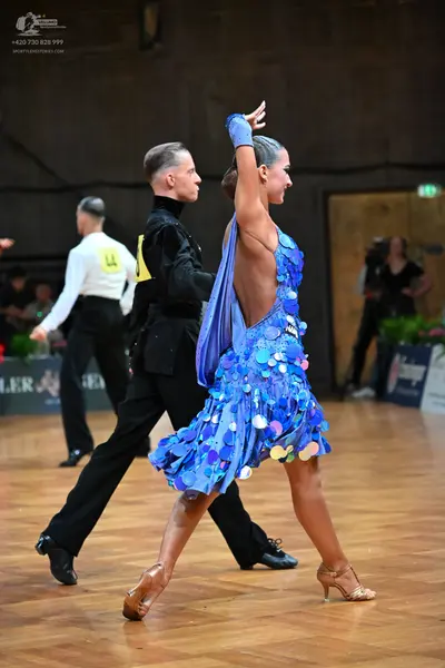 Dancesport competitor: Male dancer: black long-sleeved shirt and black trousers
