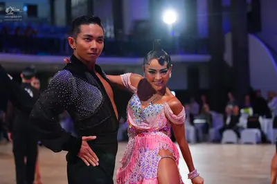 Dancesport competitor: Male dancer: black Latin dance shirt with a sequined chest panel and black trous
