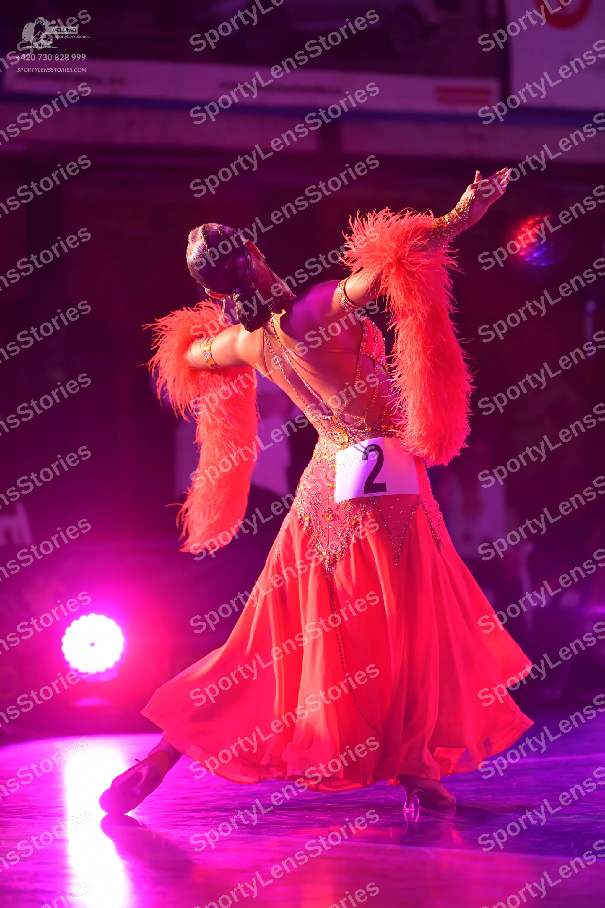 Dancesport competitor #2: ** Red Latin dress
* **Color:** Predominantly vibrant red
* **Fabric:** Like