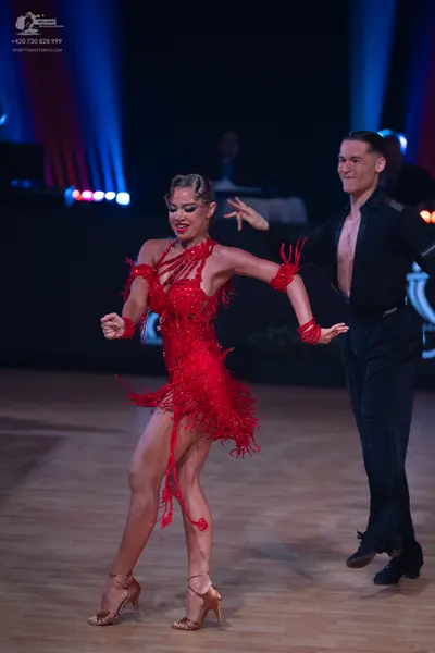 Dancesport competitor: Female dancer: red latin dress with sequins and fringe