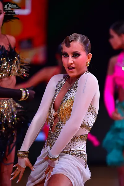 Dancesport competitor: Dancer on the left: black latin dress with gold/silver sequins and fringe