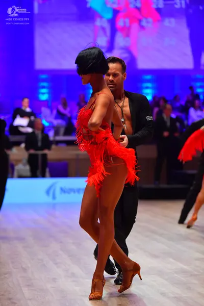 Dancesport competitor: Female dancer: red latin dress with fringe