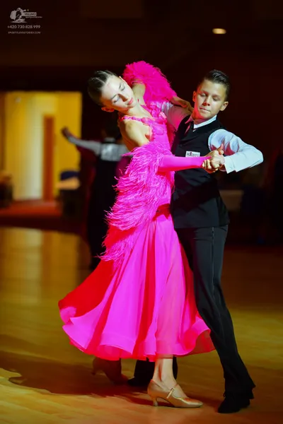 Dancesport competitor: Female dancer: bright pink Latin dress with pink feathers