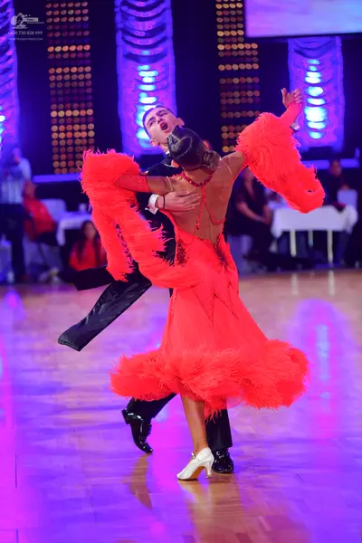 Dancesport competitor: Male dancer: black dance attire consisting of a black shirt and trousers