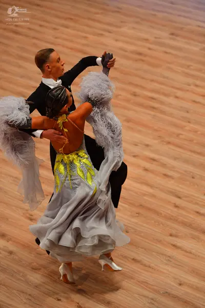 Dancesport competitor: Male dancer: black tuxedo jacket, white shirt, and black bowtie