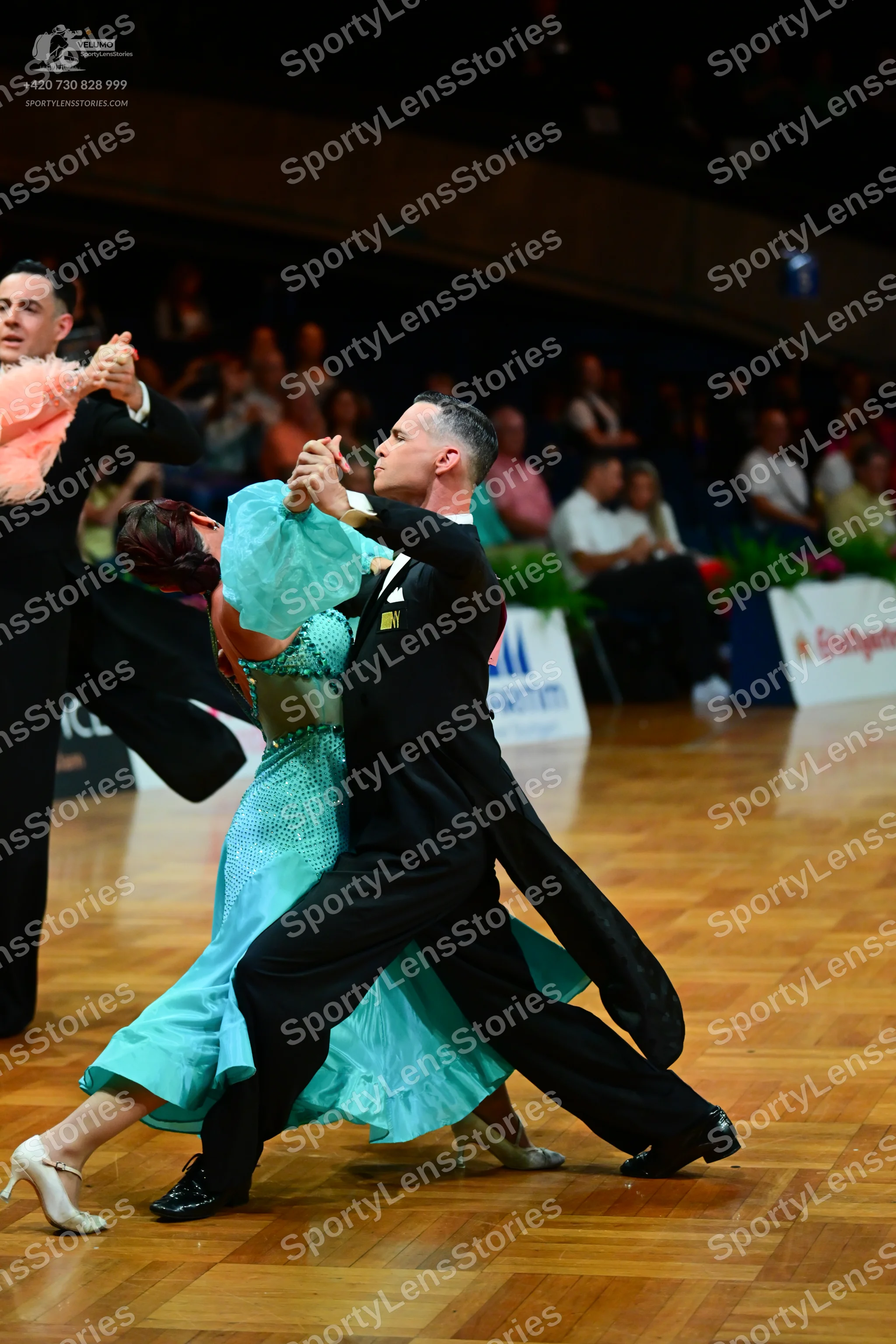 Dancesport competitor: Male dancer: black tailcoat-style suit with black trousers and black shoes