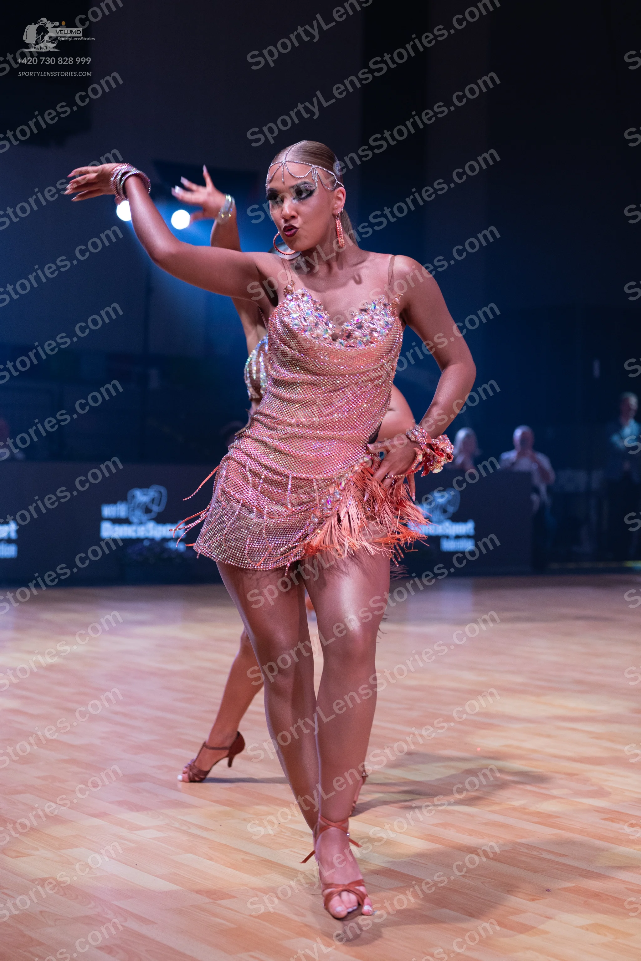 Dancesport competitor: Female dancer: light peach Latin dance dress with a sequined bodice, spaghetti s