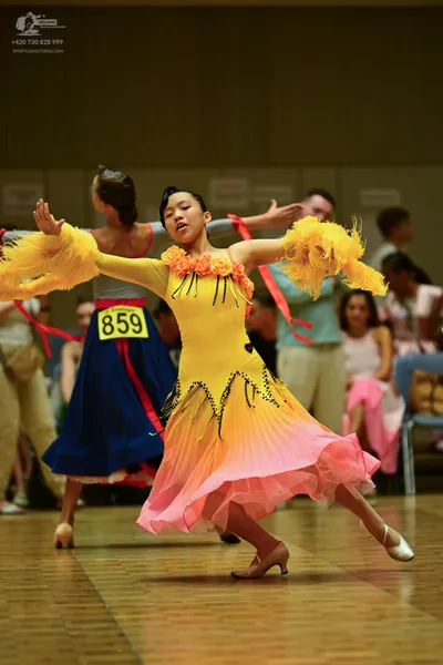 Dancesport competitor #8591: ** Yellow (light peach) fitted bodice with flowing, layered skirt