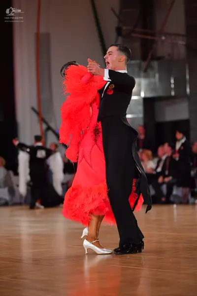Dancesport competitor: Male dancer: black tailcoat suit with black trousers and black dance shoes