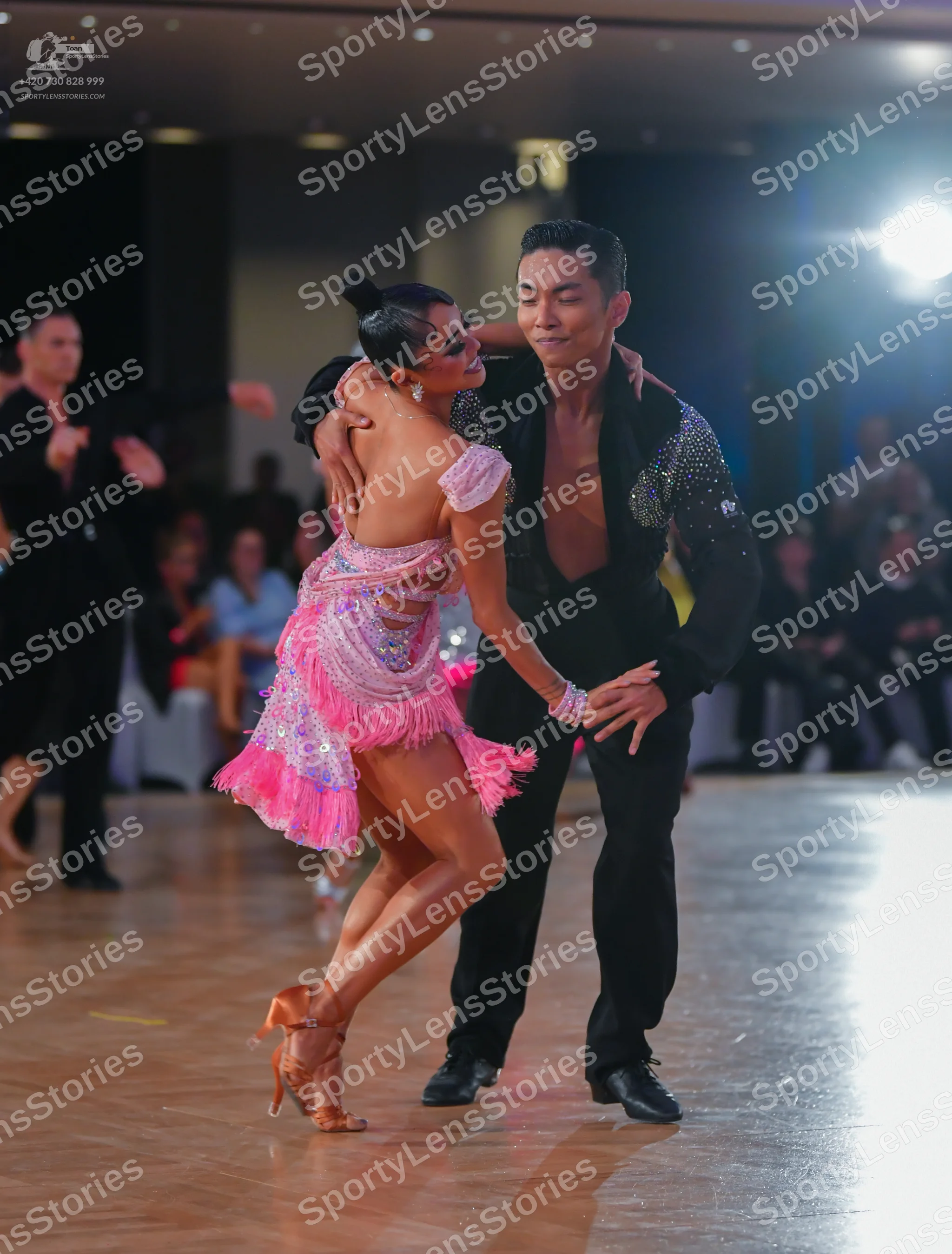 Dancesport competitor: Female dancer: pink and lavender sequined Latin dance dress with long pink fring