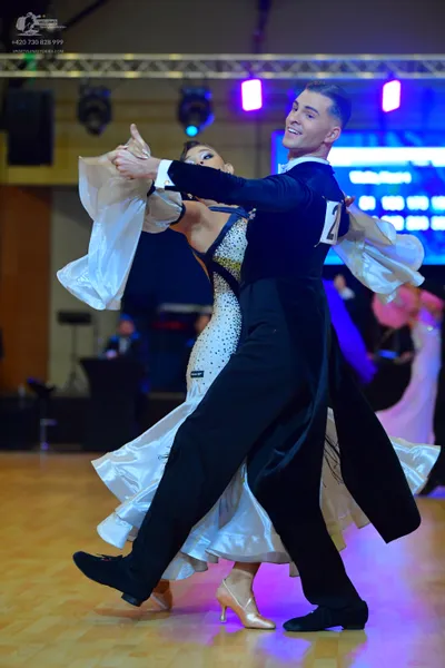Dancesport competitor: ** Male: Black tail suit with silver sequin accents and a silver bow tie