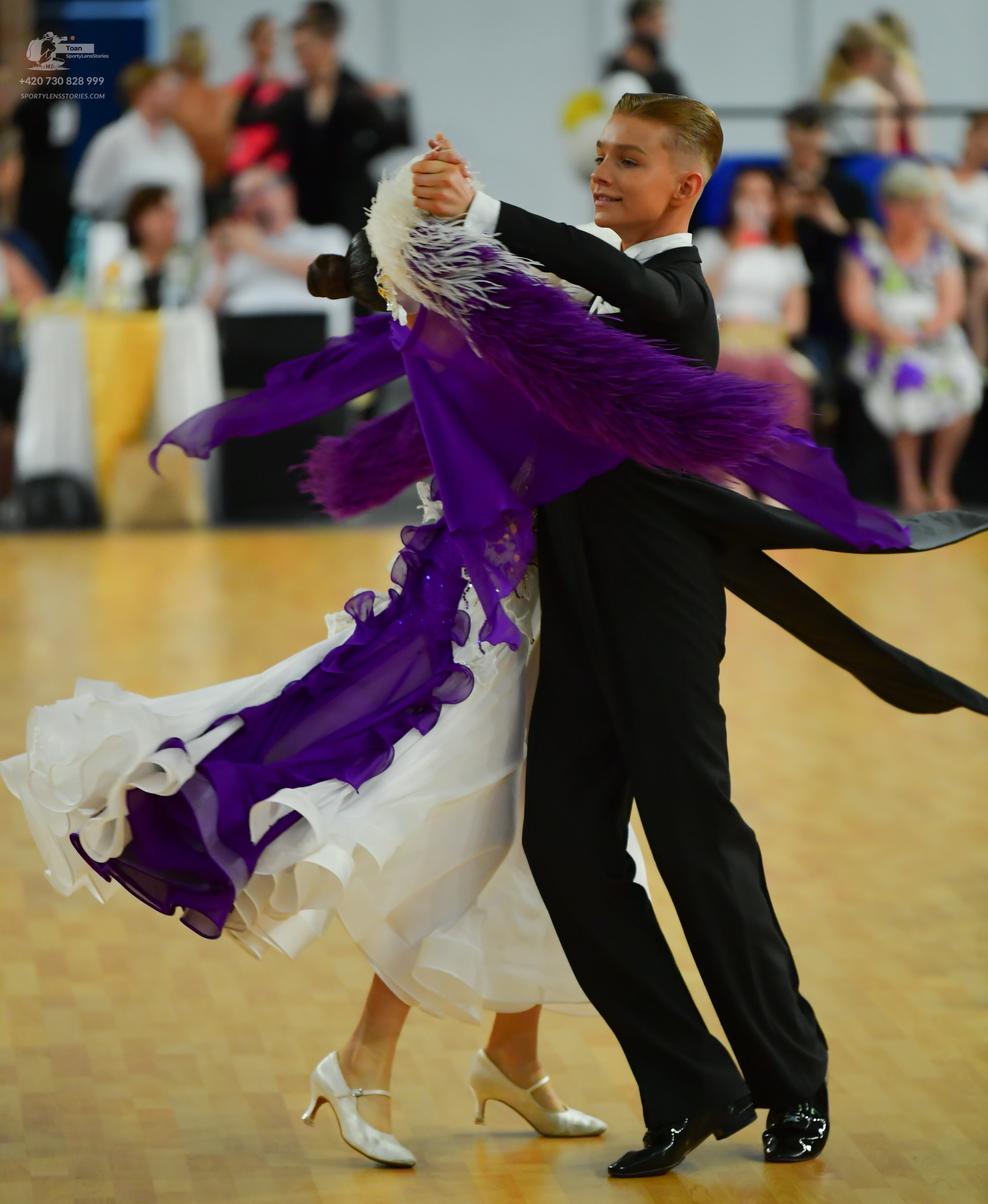 Dancesport competitor: Male:** Black tail suit with silver sequin lapels and a black tie