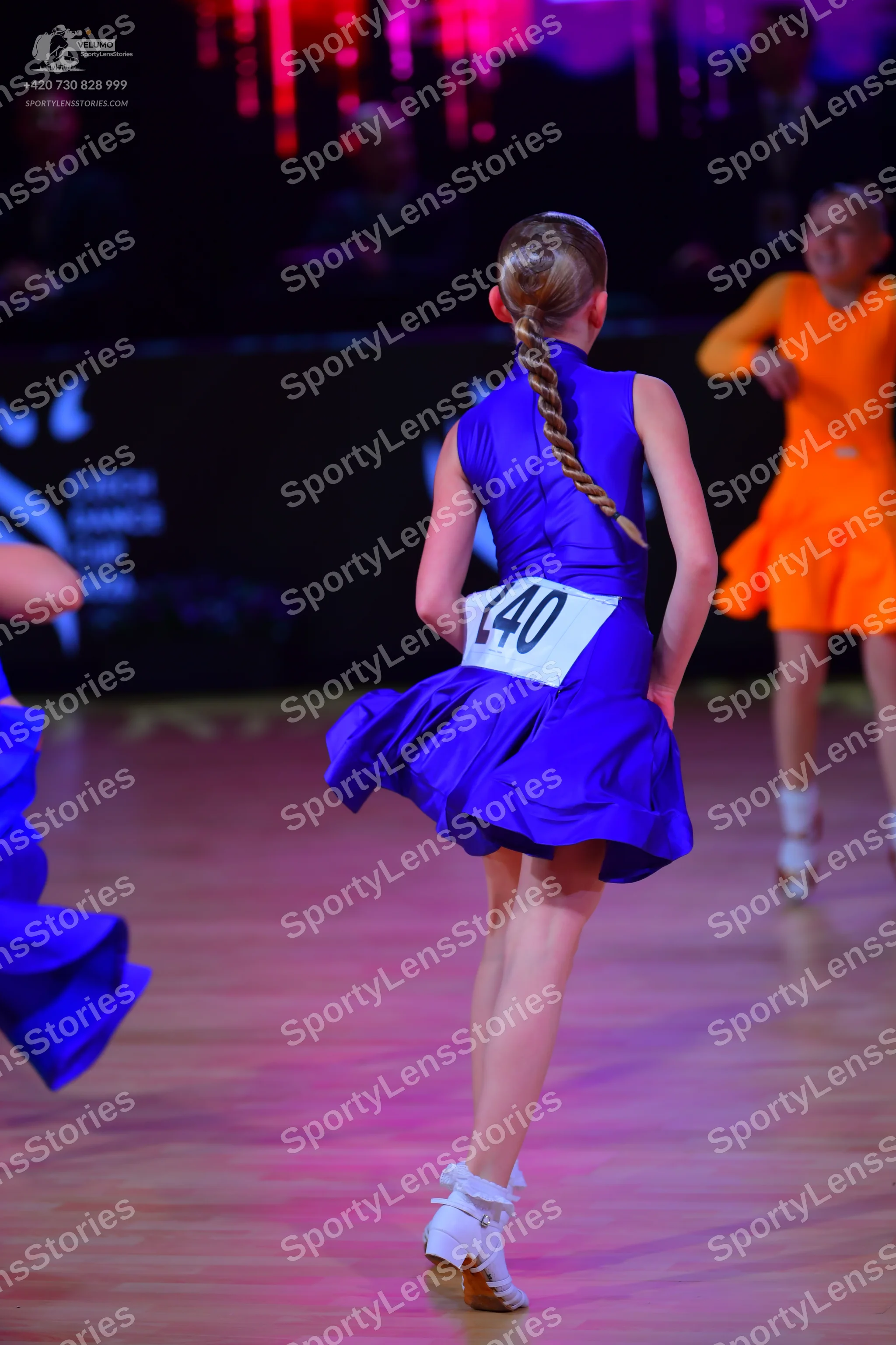 Dancesport competitor: Female dancer: blue sleeveless latin dress with a flared skirt