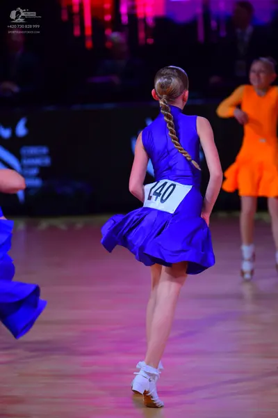 Dancesport competitor: Female dancer: blue sleeveless latin dress with a flared skirt