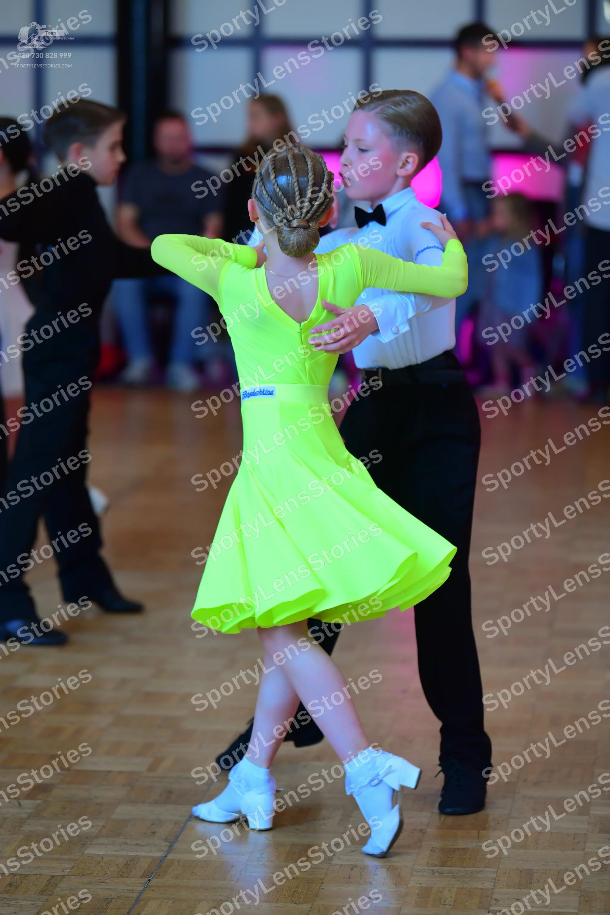 Dancesport competitor: Female dancer: lime green long-sleeved latin dress with a flared skirt