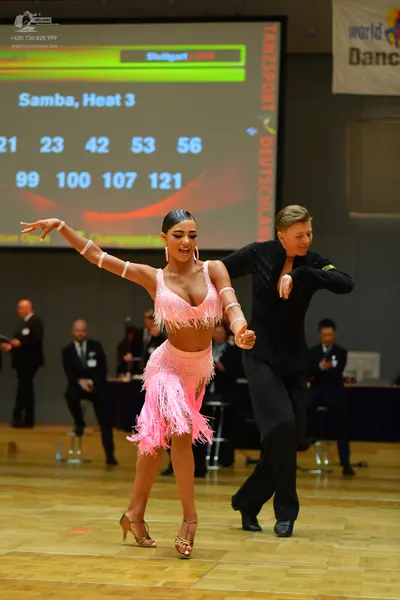 Dancesport competitor: Female dancer: pink latin dress with fringe