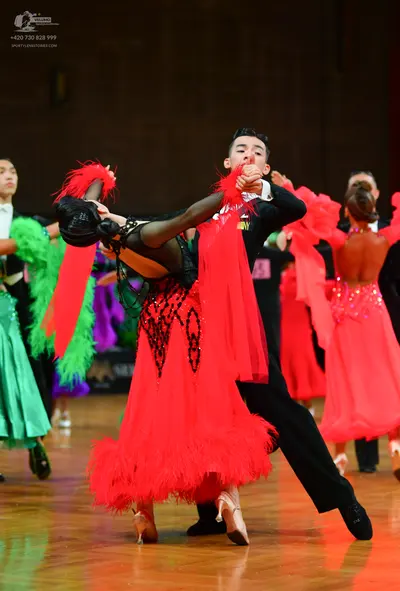 Dancesport competitor: Male dancer: black suit, black trousers, and black shoes