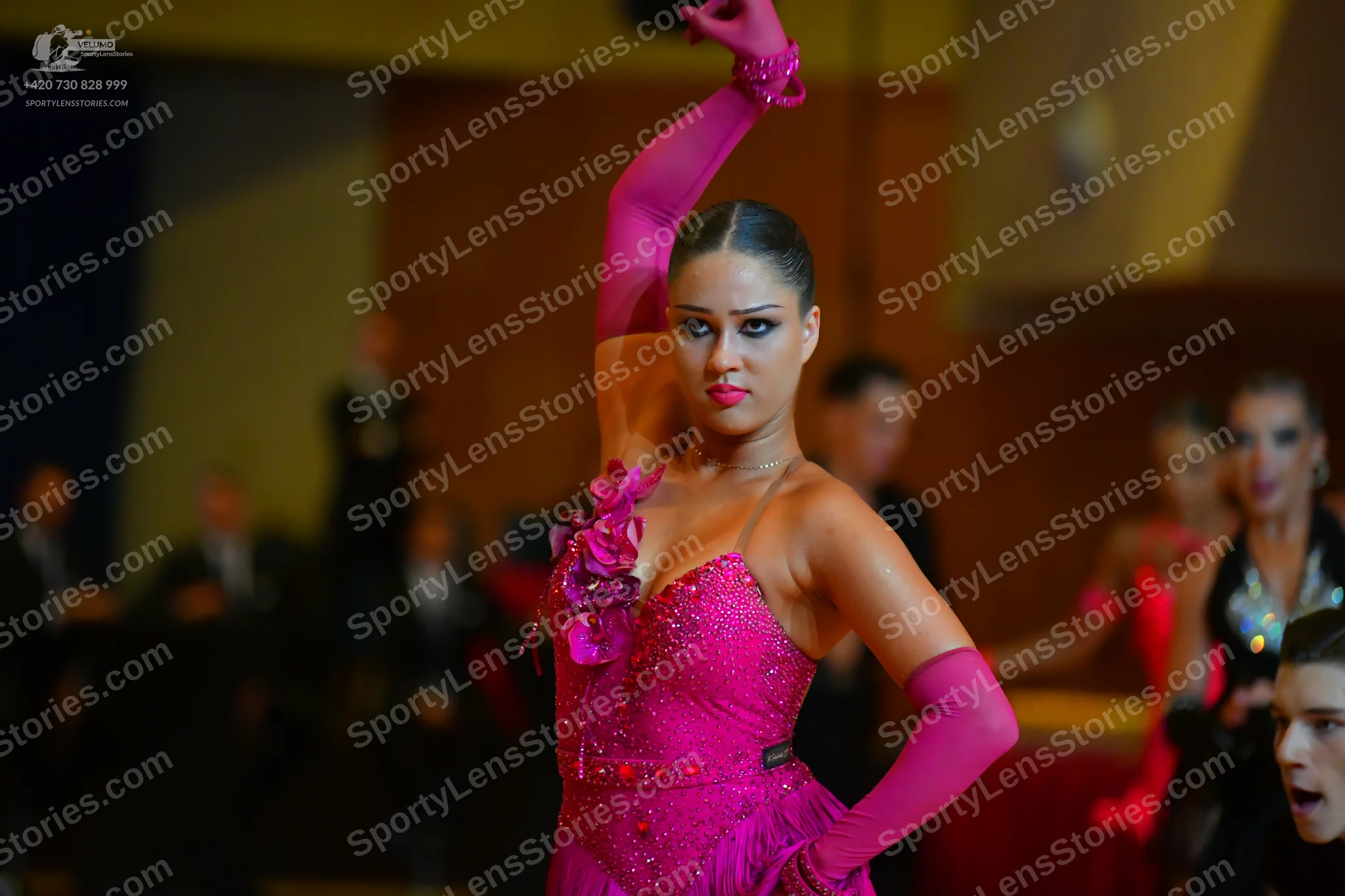 Dancesport competitor: Main female dancer: bright pink latin dress with floral appliqués and sequins, w