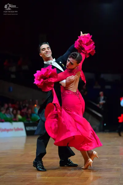 Dancesport competitor: Male dancer: black suit with a white shirt and white bow tie
