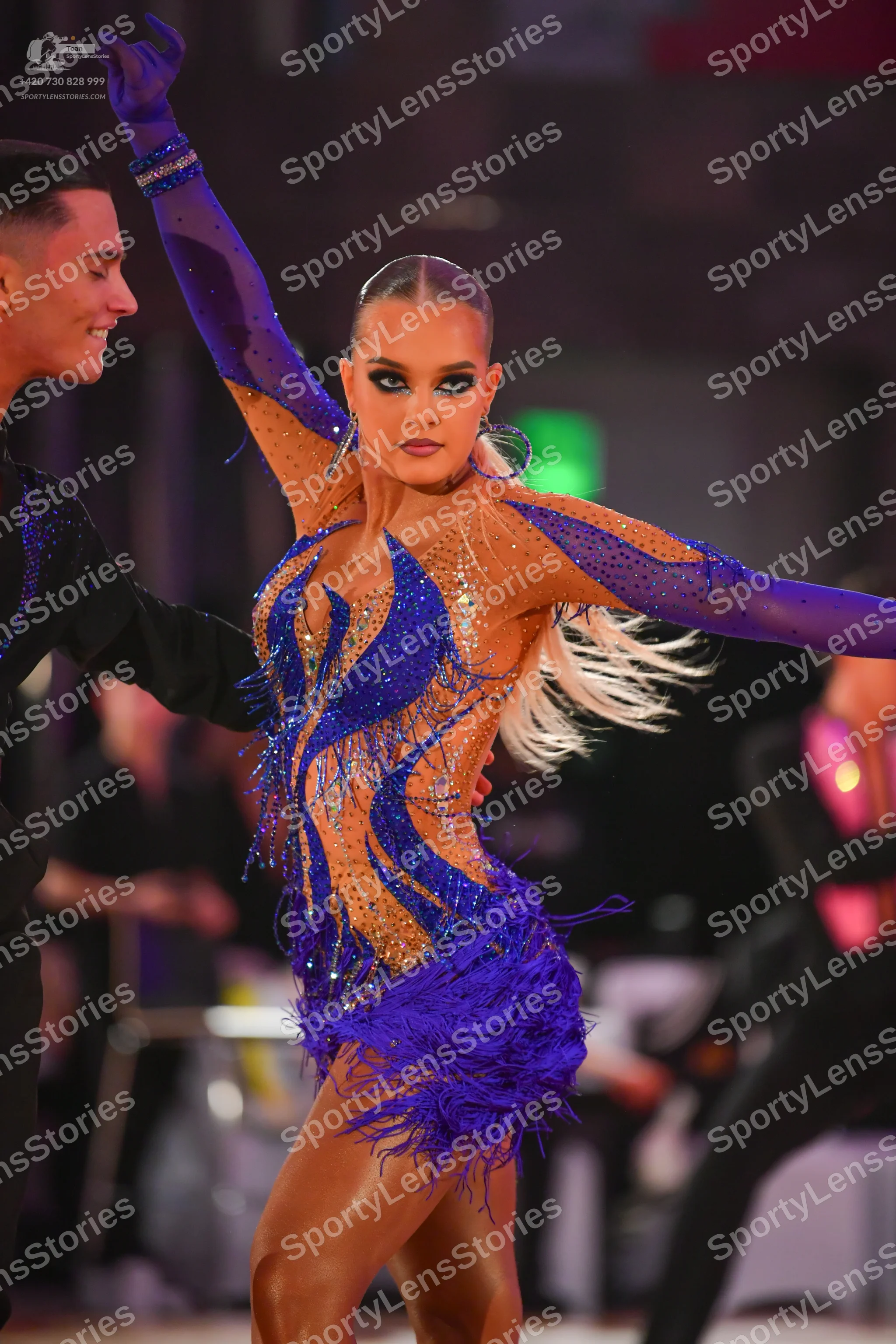 Dancesport competitor: Female dancer: blue and nude-colored Latin dance dress with heavy blue sequin/rh