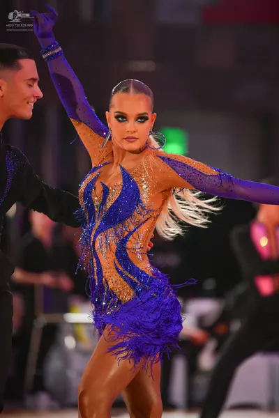 Dancesport competitor: Female dancer: blue and nude-colored Latin dance dress with heavy blue sequin/rh