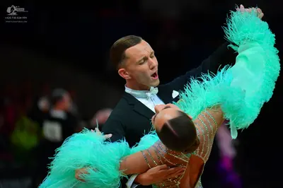 Dancesport competitor: Male dancer: black suit with a white shirt and white bow tie