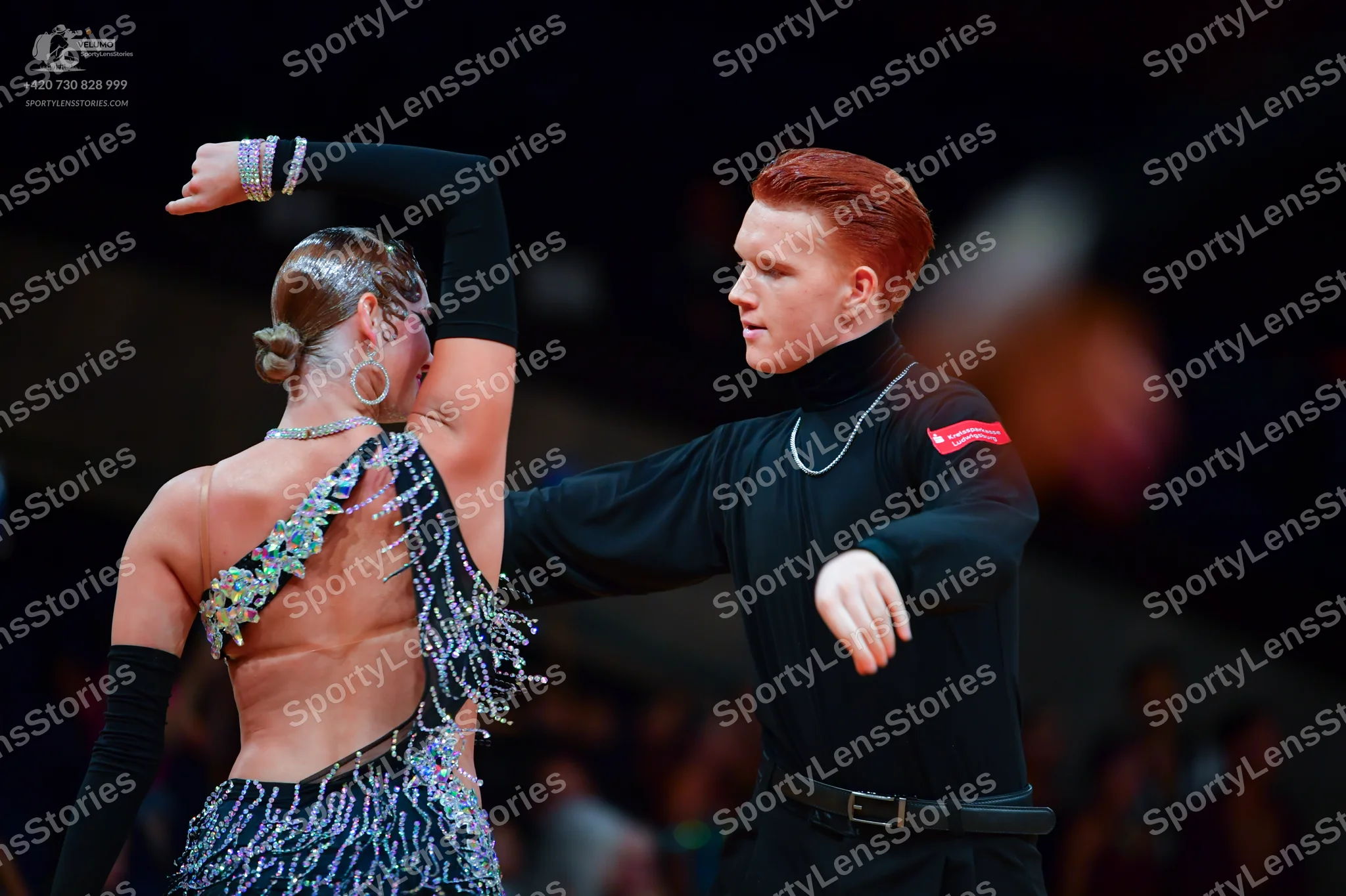 Dancesport competitor: Male dancer: black long-sleeved turtleneck and black trousers with a black belt,