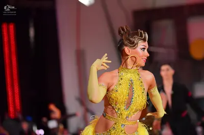 Dancesport competitor: Female dancer: yellow/gold Latin dance dress with heavy sequin/crystal embellish
